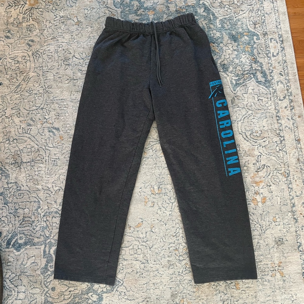Dark gray Carolina Panthers sweatpants with pockets and elastic waist and ties